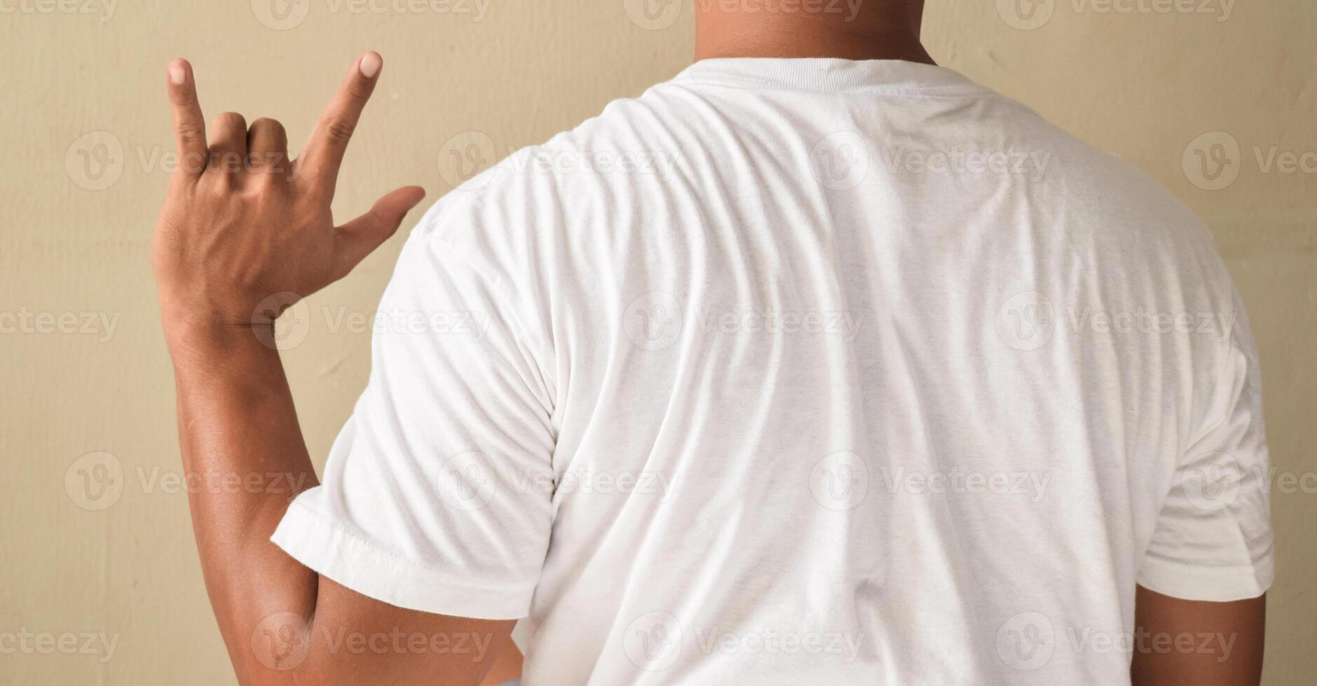 Young man showing I Love You on sign language photo