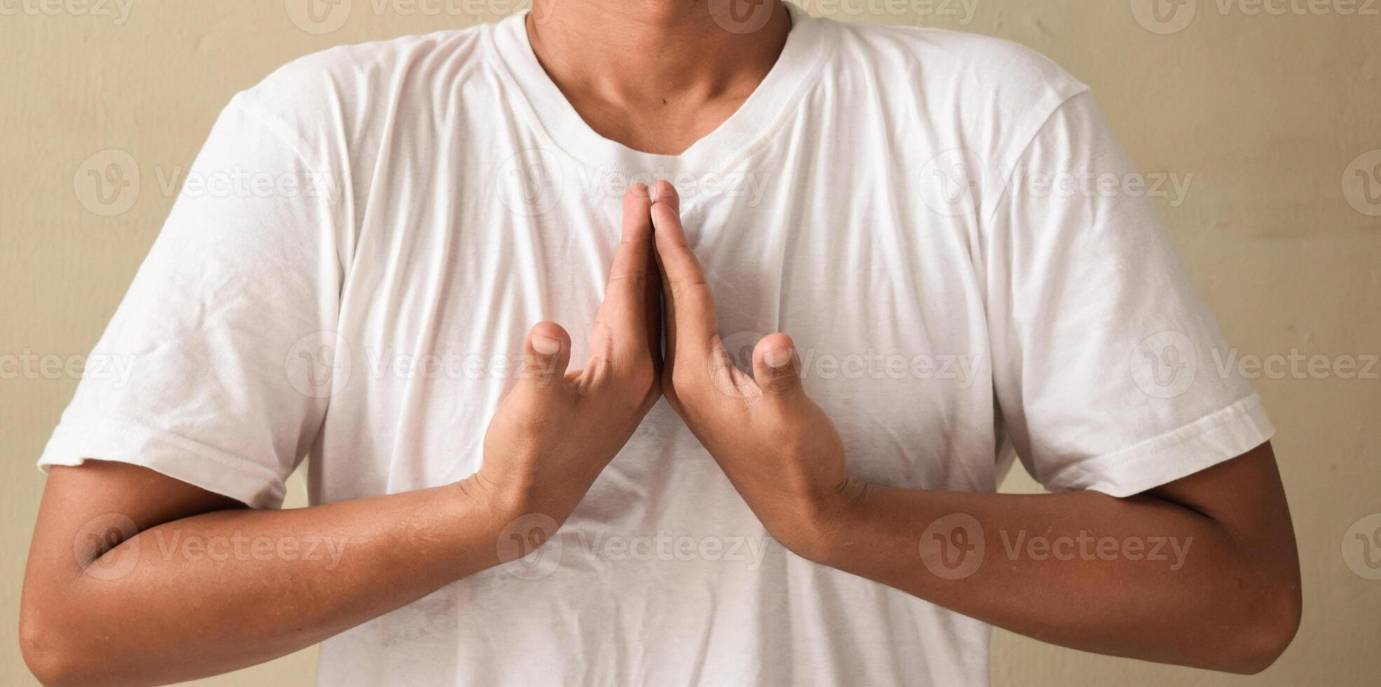 Young man showing gesture meaning happy on sign language photo
