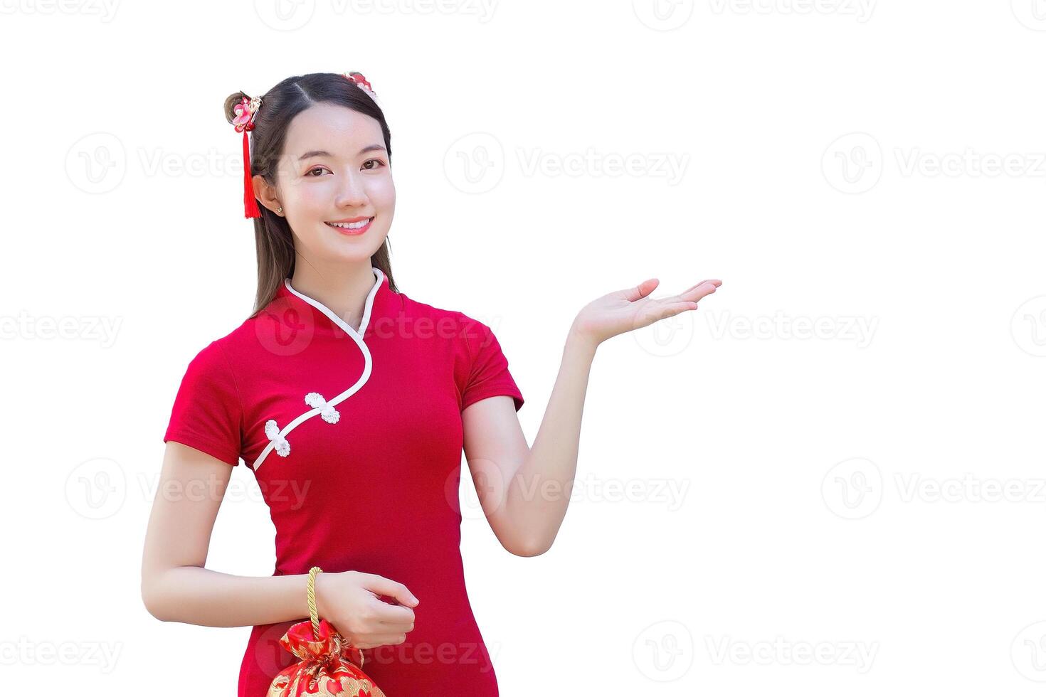 Asian beautiful confident woman in red dress stands holding red bag is pointing hand to present something while isolated white background in Chinese new year theme. photo