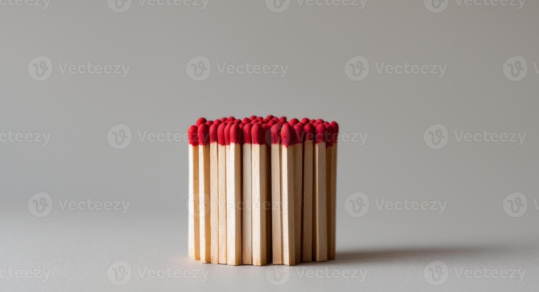 Several wooden matches with red tips are displayed. photo