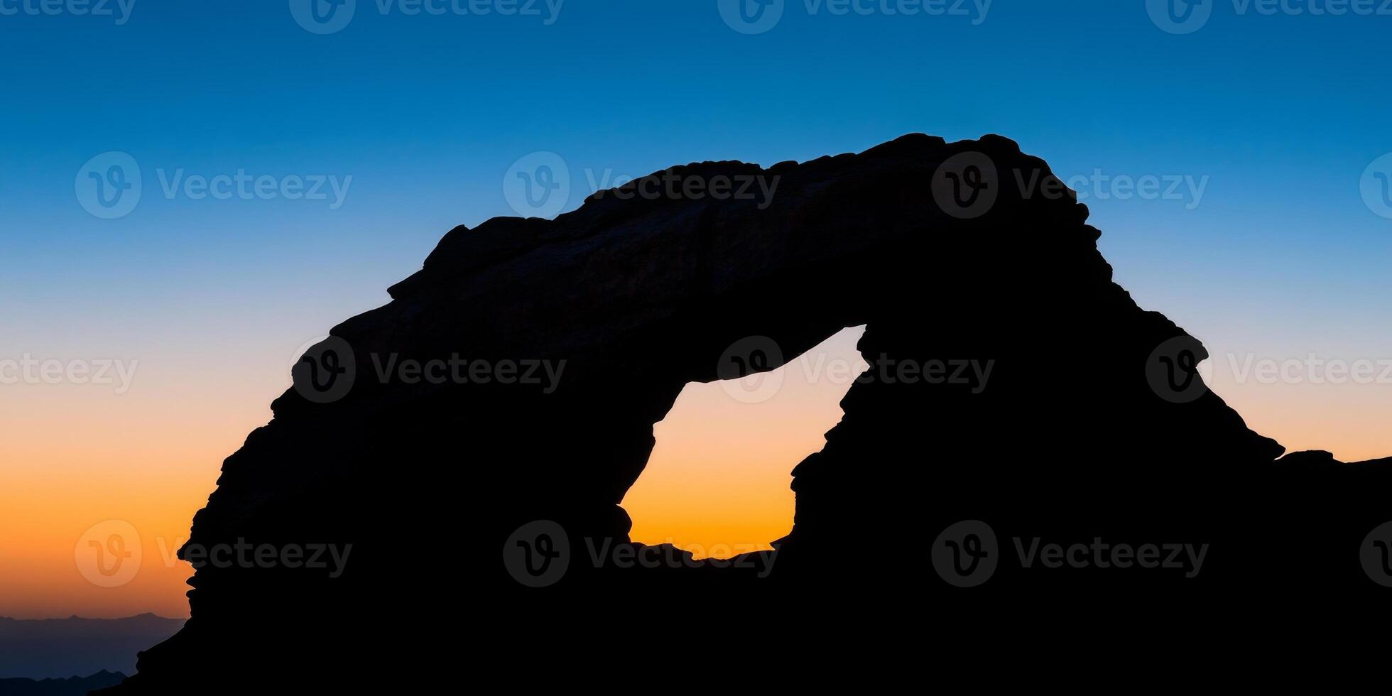 A rock archway with a hole in the middle photo