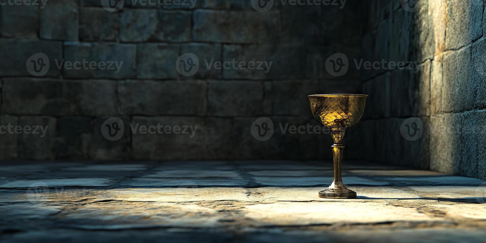 A golden cup is sitting on a stone floor in a dimly lit room photo