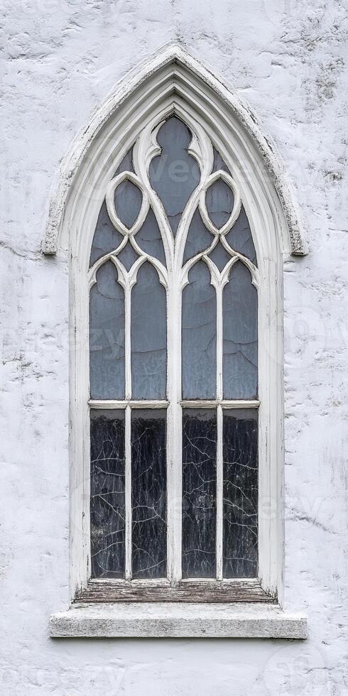 A window with a white frame and a blue stained glass window photo