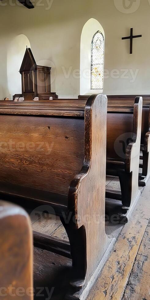 A church with wooden pews and a cross on the wall photo