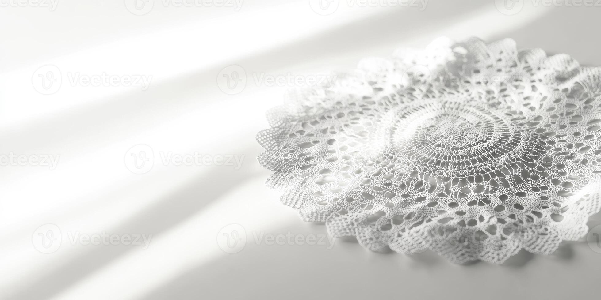 A white lace doily sits on a white table photo