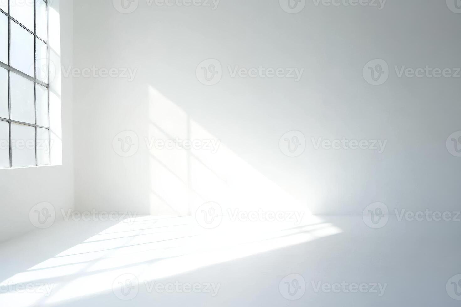 A room with a window and a white wall photo