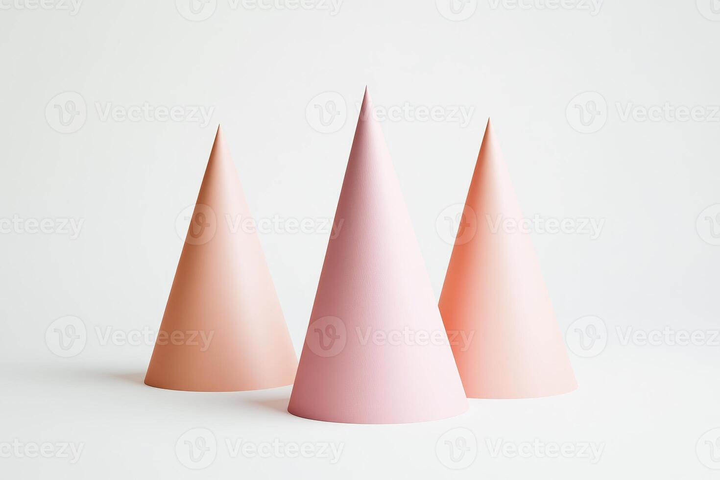 Three pink cone shaped objects. They are all the same size. They are all standing on a white background photo