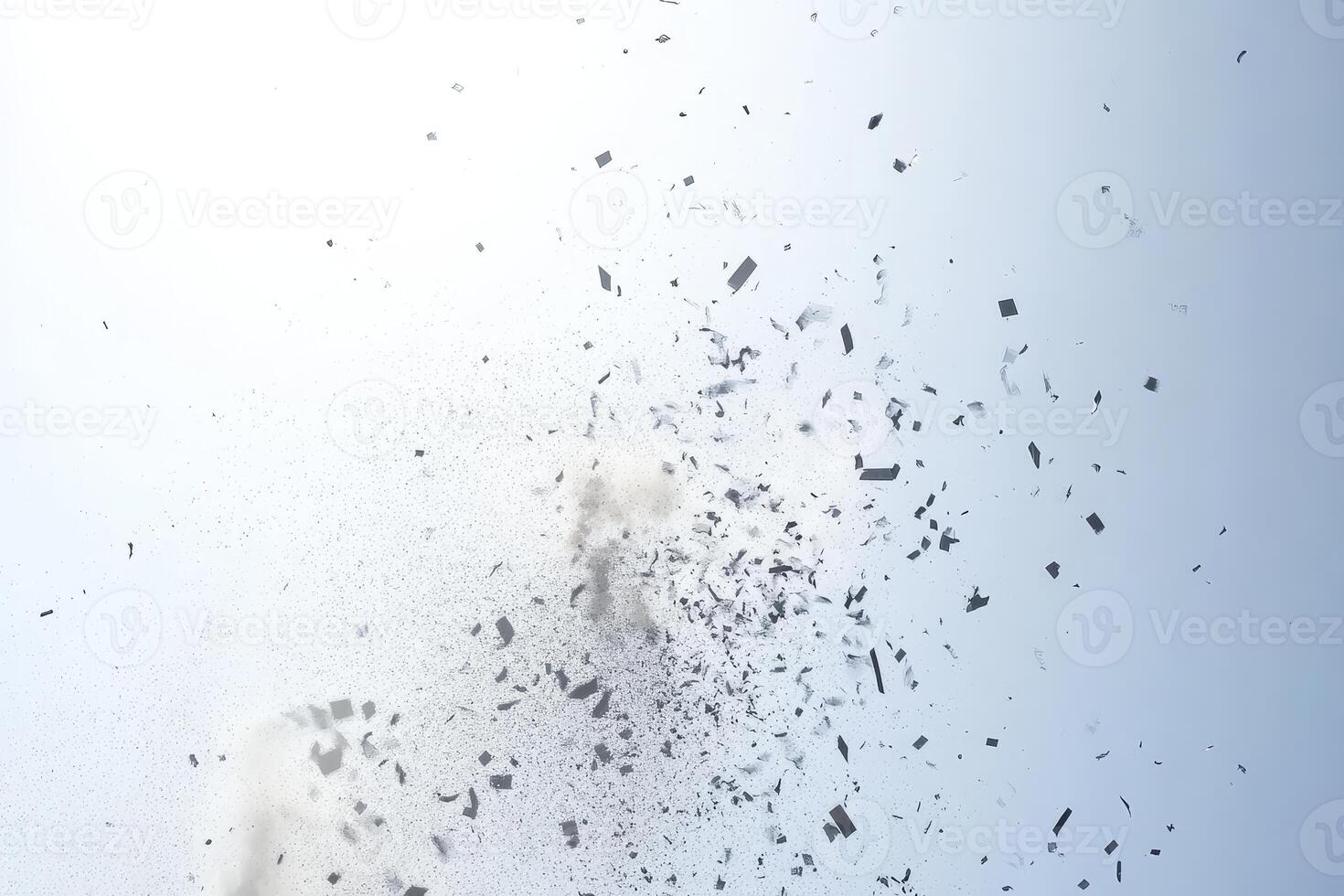 A cloud of dust is in the air. The dust is white and gray. The sky is blue photo
