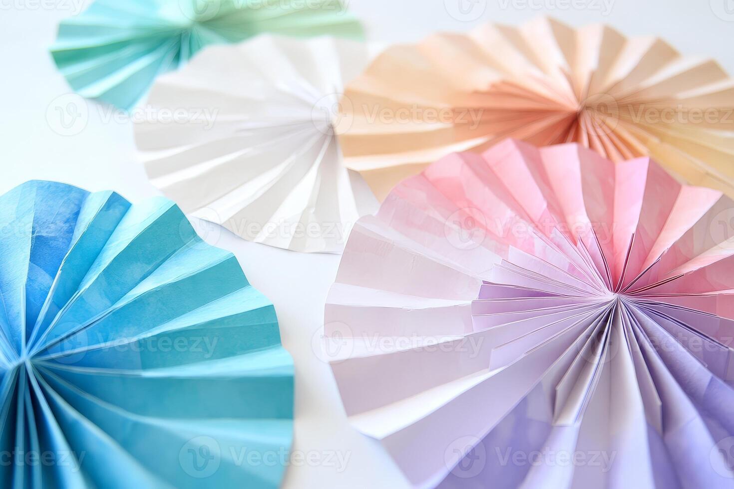 A bunch of paper fans are on a white background. The fans are in different colors and sizes photo