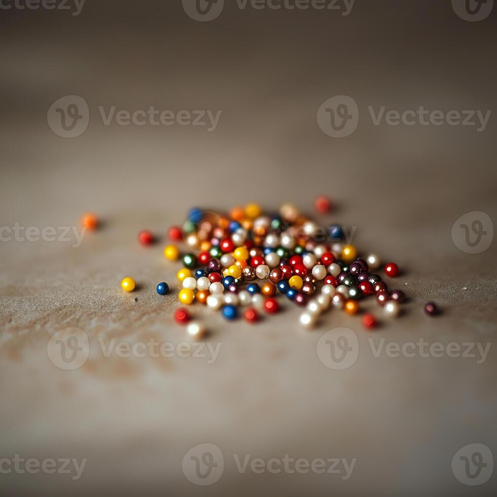 A vibrant collection of multicolored beads scattered on a neutral surface, showcasing a blend of colors and textures in a soft focus. photo