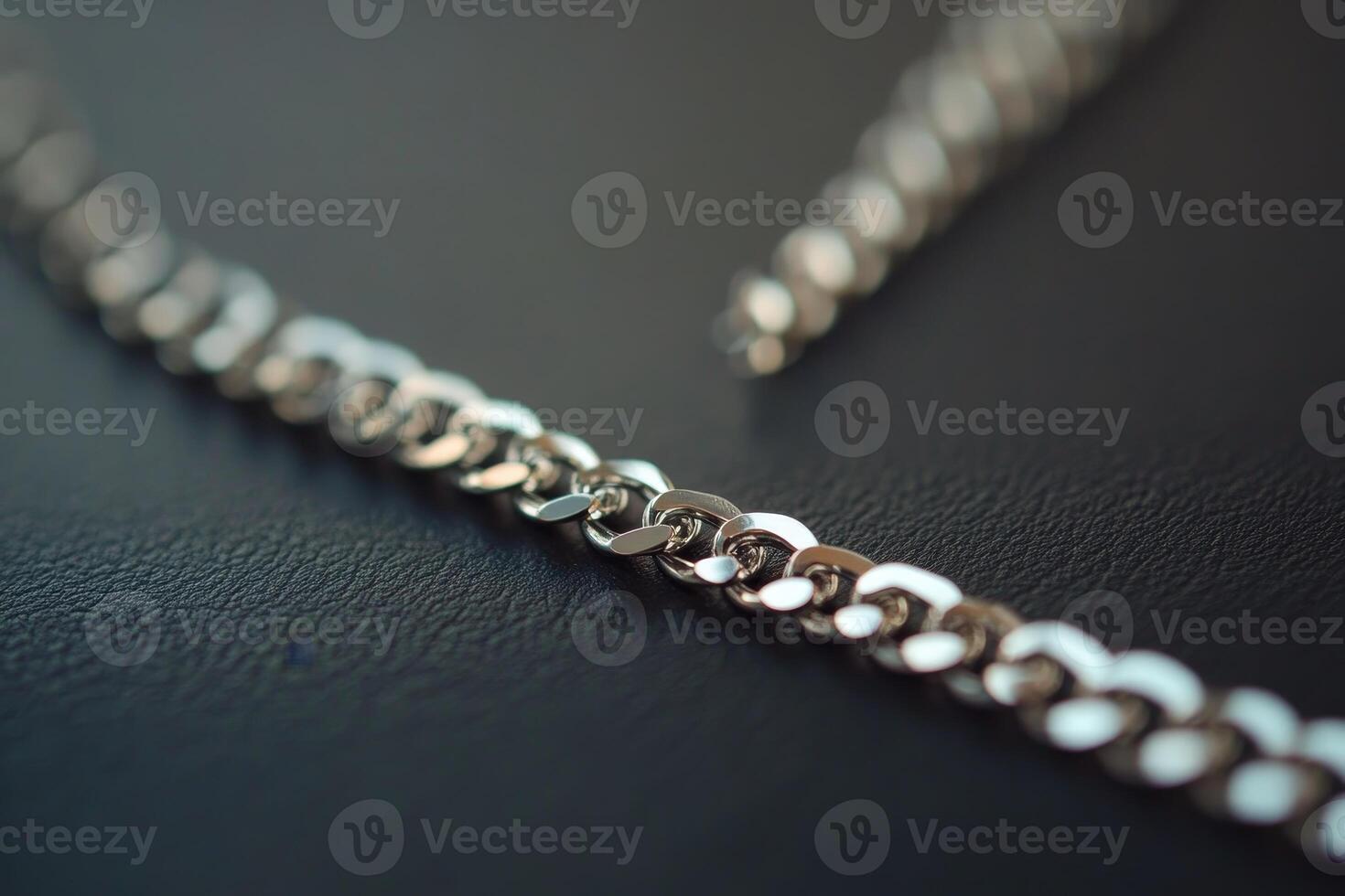 A detailed close up of a shiny silver chain showcasing intricate links against a dark background, perfect for highlighting elegance and craftsmanship in jewelry design. photo