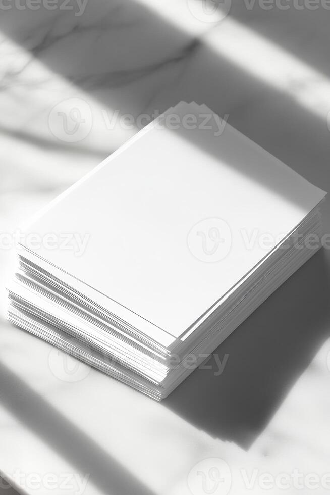 A stack of blank white paper sheets on a marble surface, illuminated by sunlight, casting soft shadows for a minimalist aesthetic. photo
