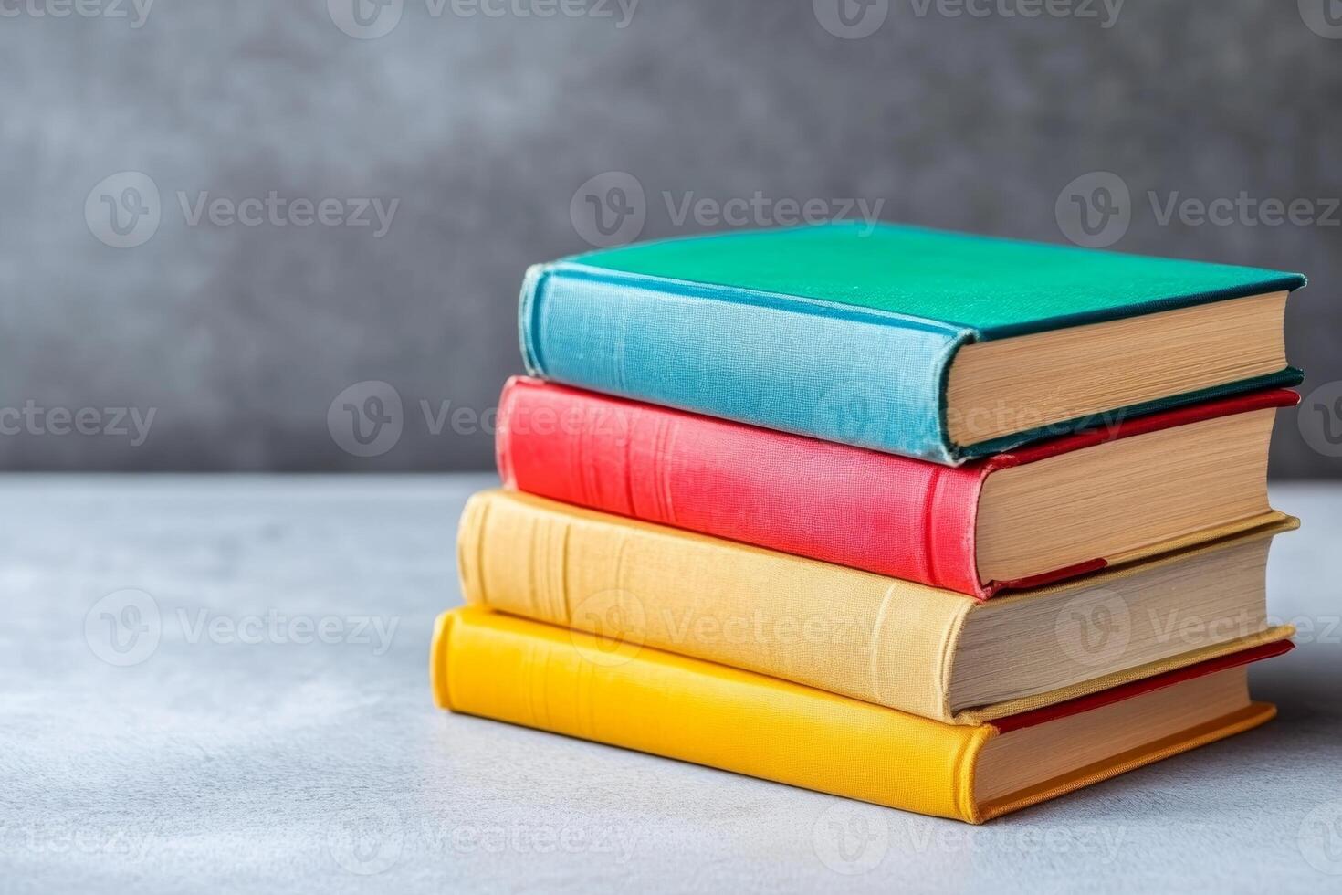 Colorful Small Stack of Books on a Table Edge with Simple Background photo