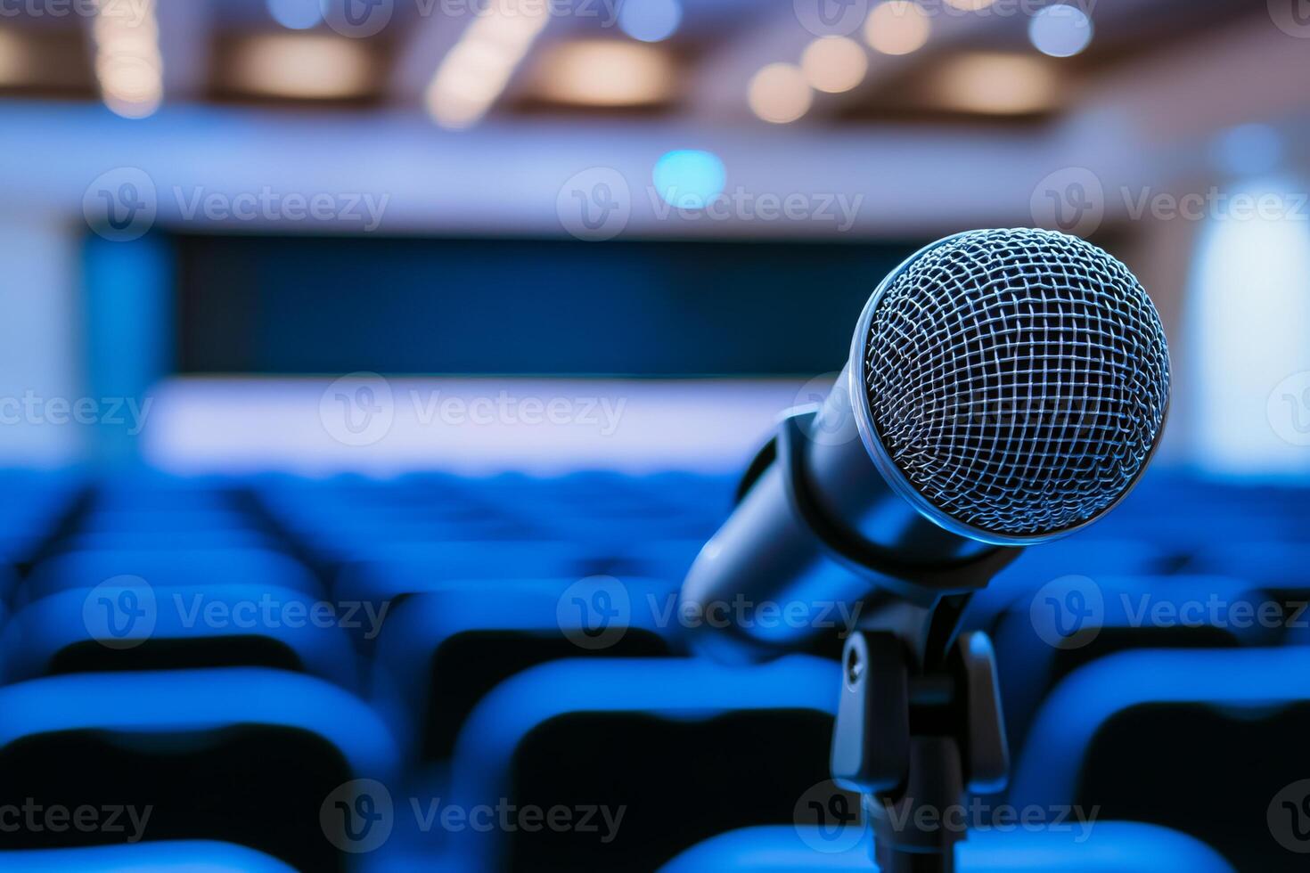 A microphone is on a stand in front of a blue background photo