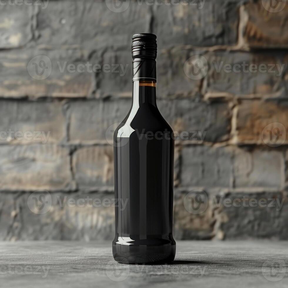 A black wine bottle with a black cap sits on a grey surface photo