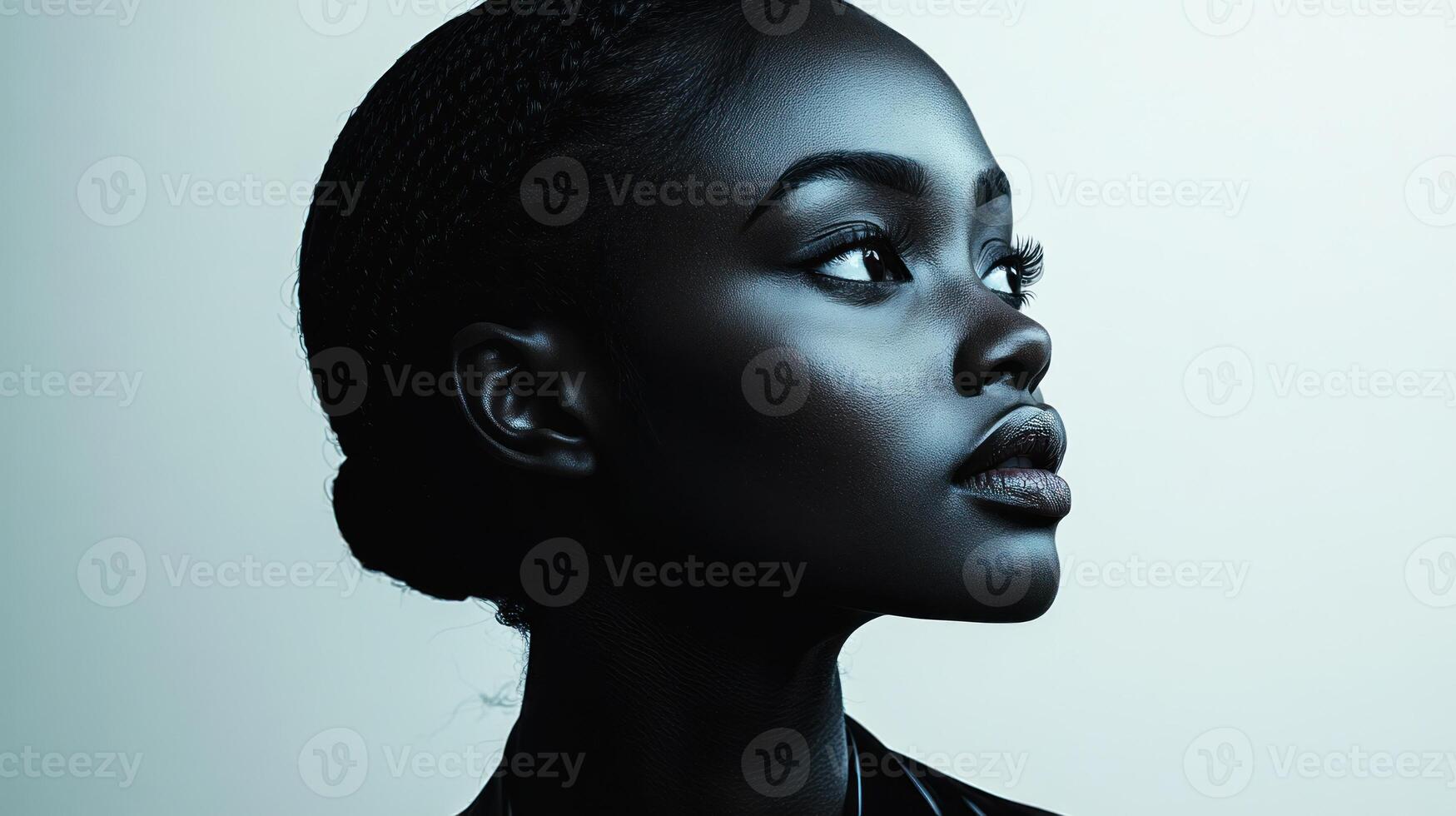 Soft lighting accentuates the graceful features of a woman's profile, creating depth photo