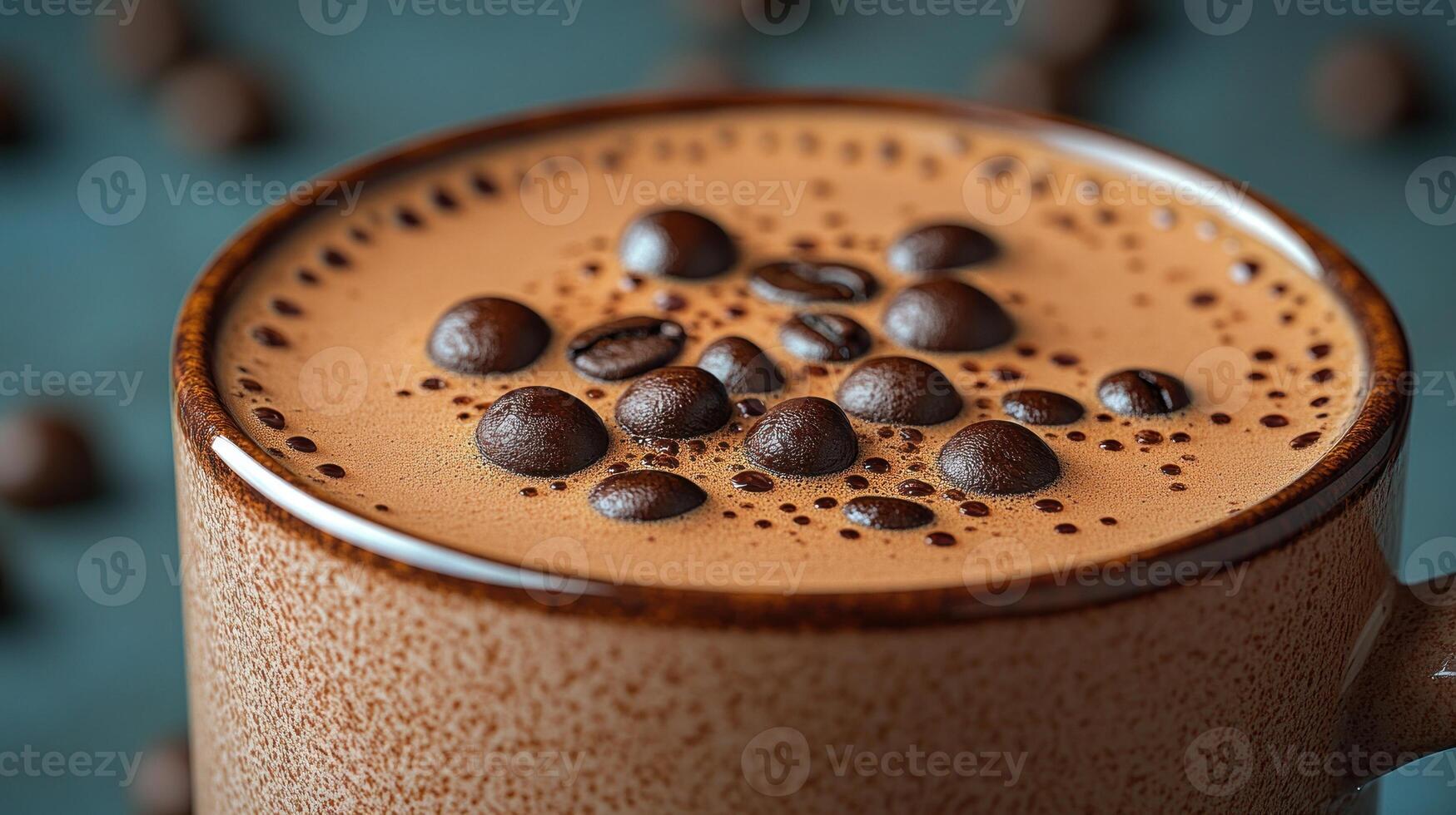 A warm cup of coffee with rich foam and roasted beans floating on top photo
