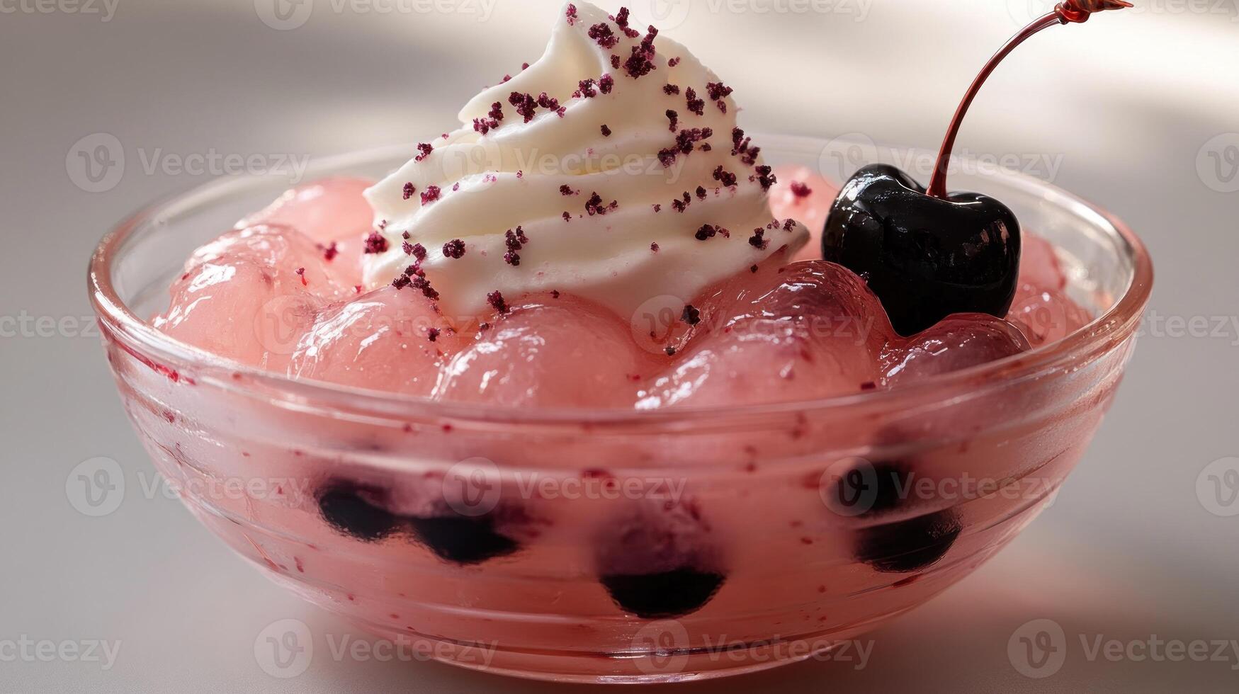 A tasty bowl features cherry jelly, whipped cream, and fresh cherries for pure indulgence photo