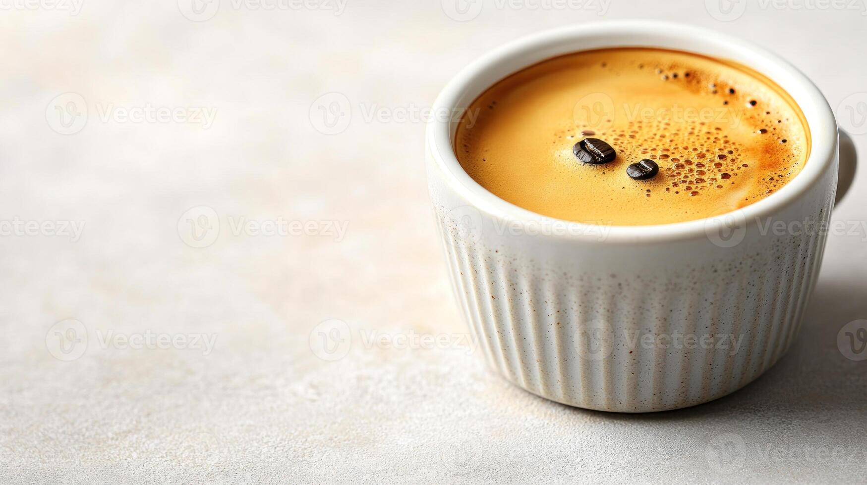An inviting espresso in a textured white cup exudes rich aromas in a serene setting photo