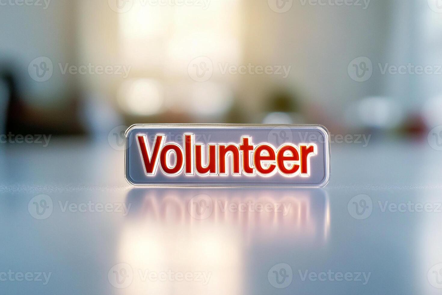 Closeup of a volunteer badge with bold red text reflecting sunlight photo