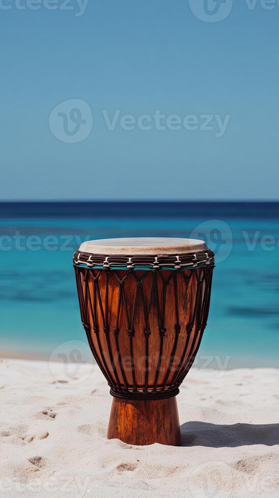 A drum sitting on a beach with the ocean in the background photo