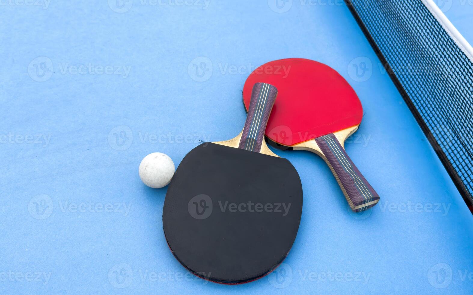 tennis rackets for playing ping pong on blue table, ping pong concept photo