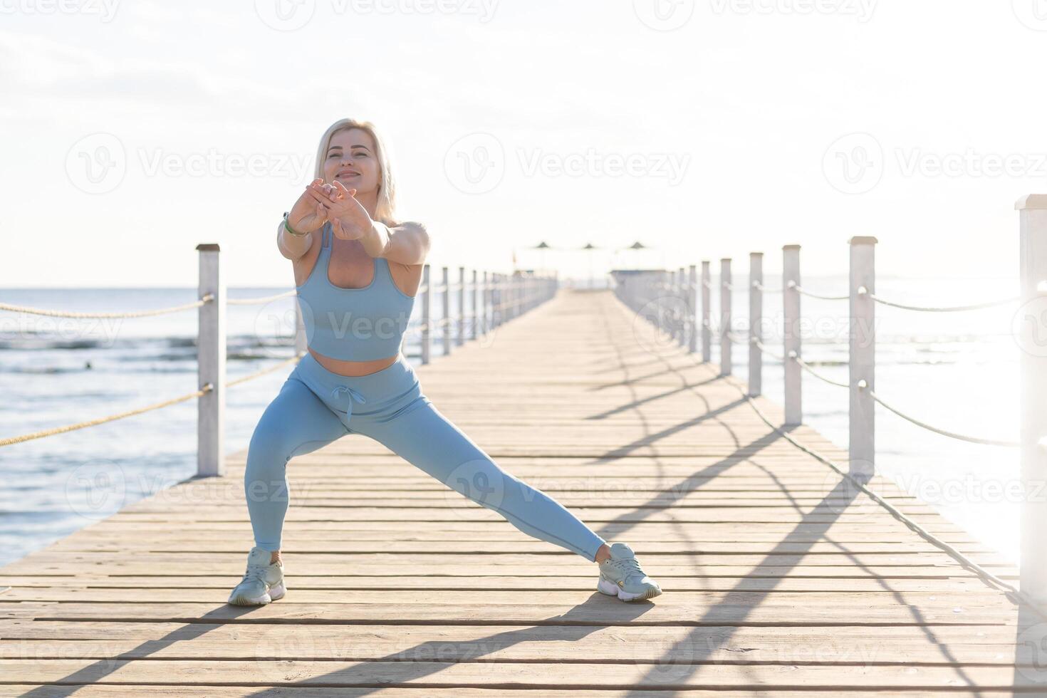Young fitness woman enjoying warm sunny day in yard of resort hotel. Tourism, vacation and weekend. photo