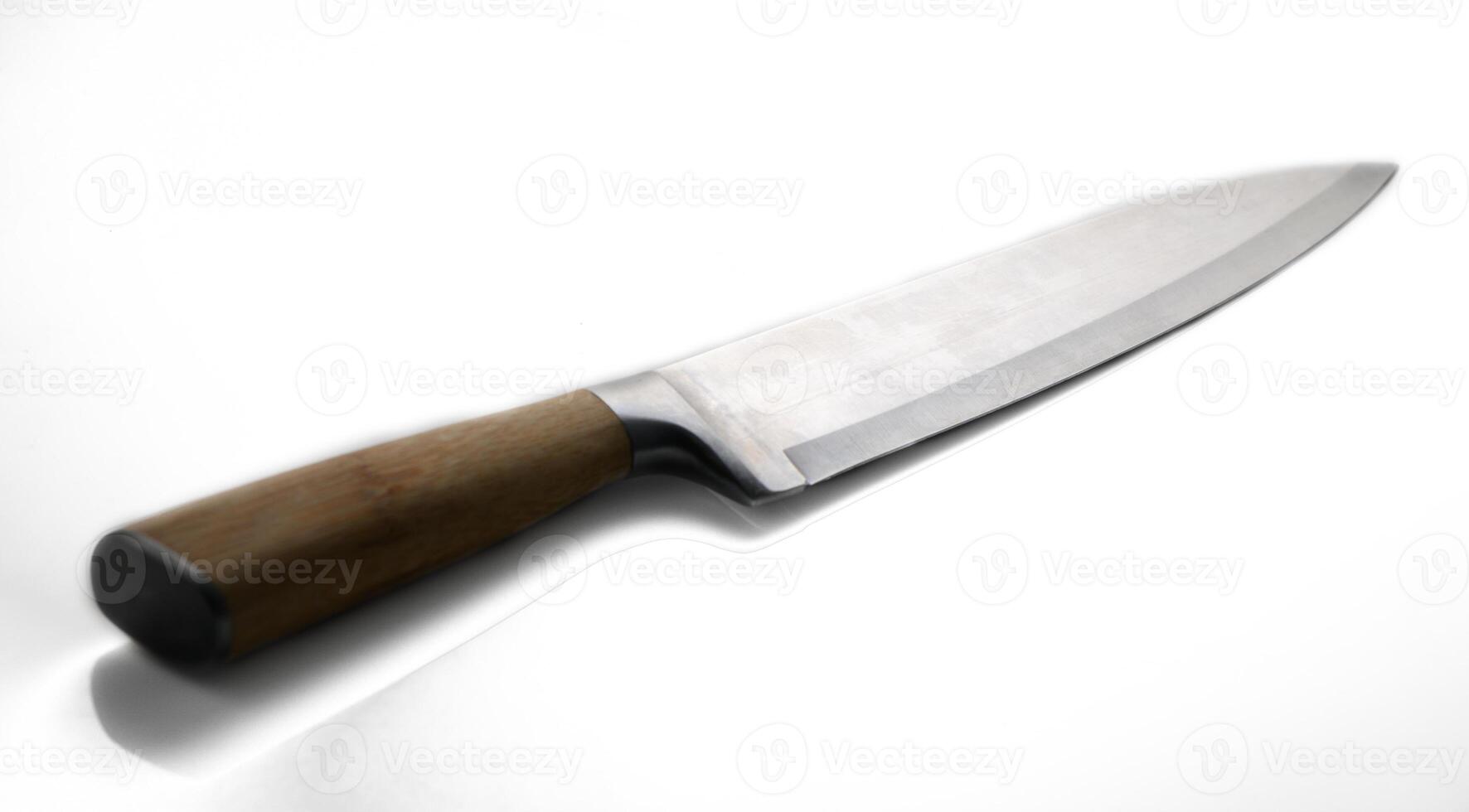 Sharp kitchen knife with wooden handle ready for culinary creation in a bright space photo