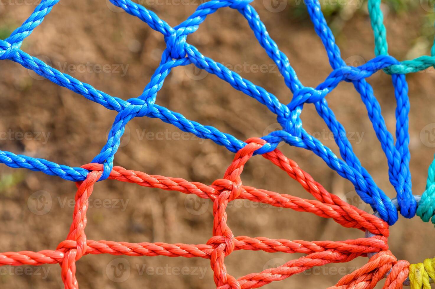 Vibrant colors of woven ropes create an intricate pattern in a sunny garden setting photo