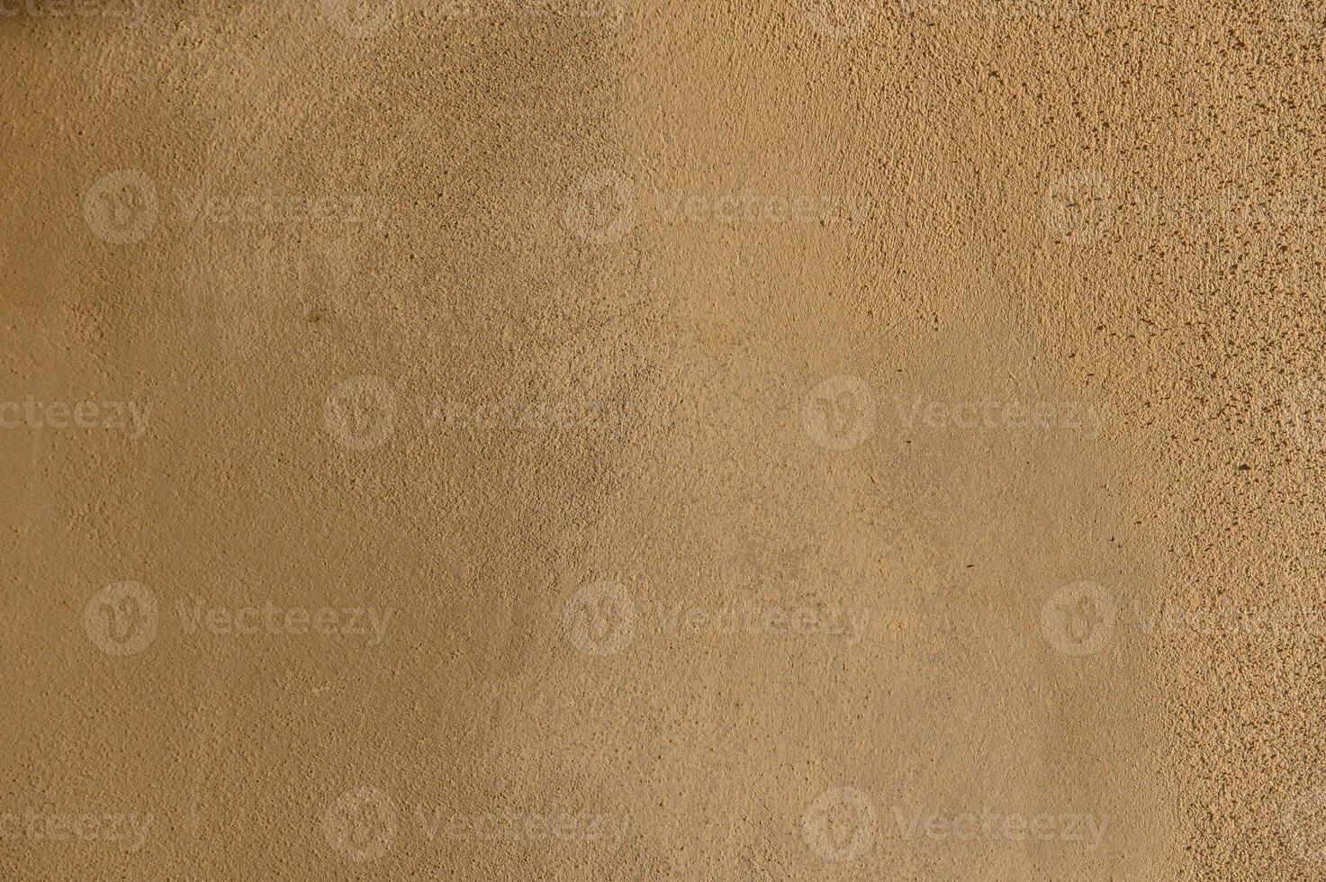 Texture of warm earth tones on a sunlit wall evokes a sense of calm and natural simplicity photo