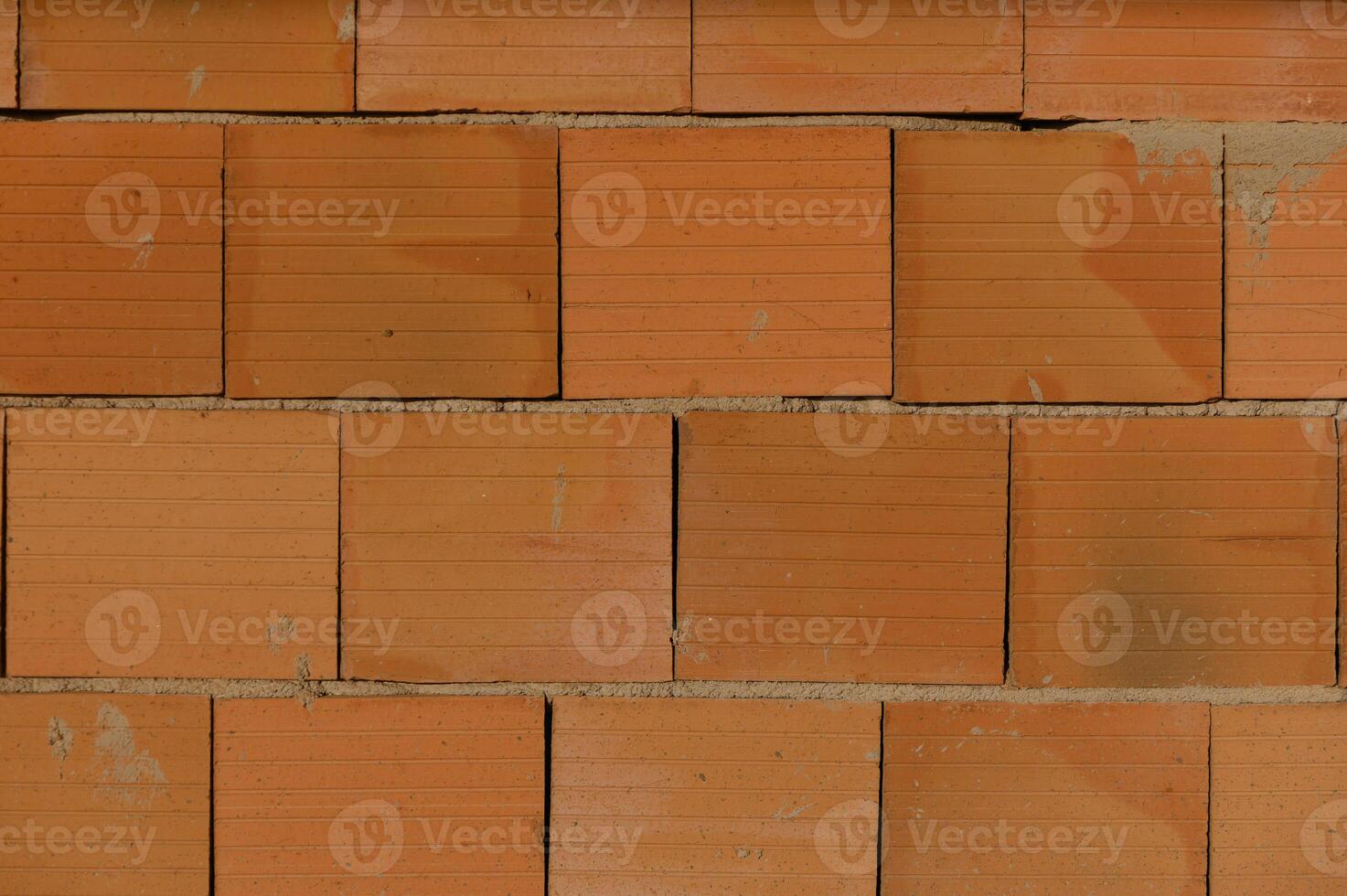 Brick wall displaying textured surface and warm hues, perfect for construction or design inspiration photo