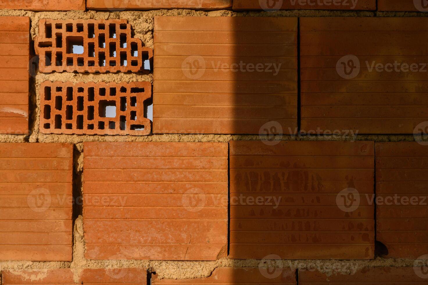 Intricate patterns in a warm-toned brick wall revealing craftsmanship and texture in a construction site photo