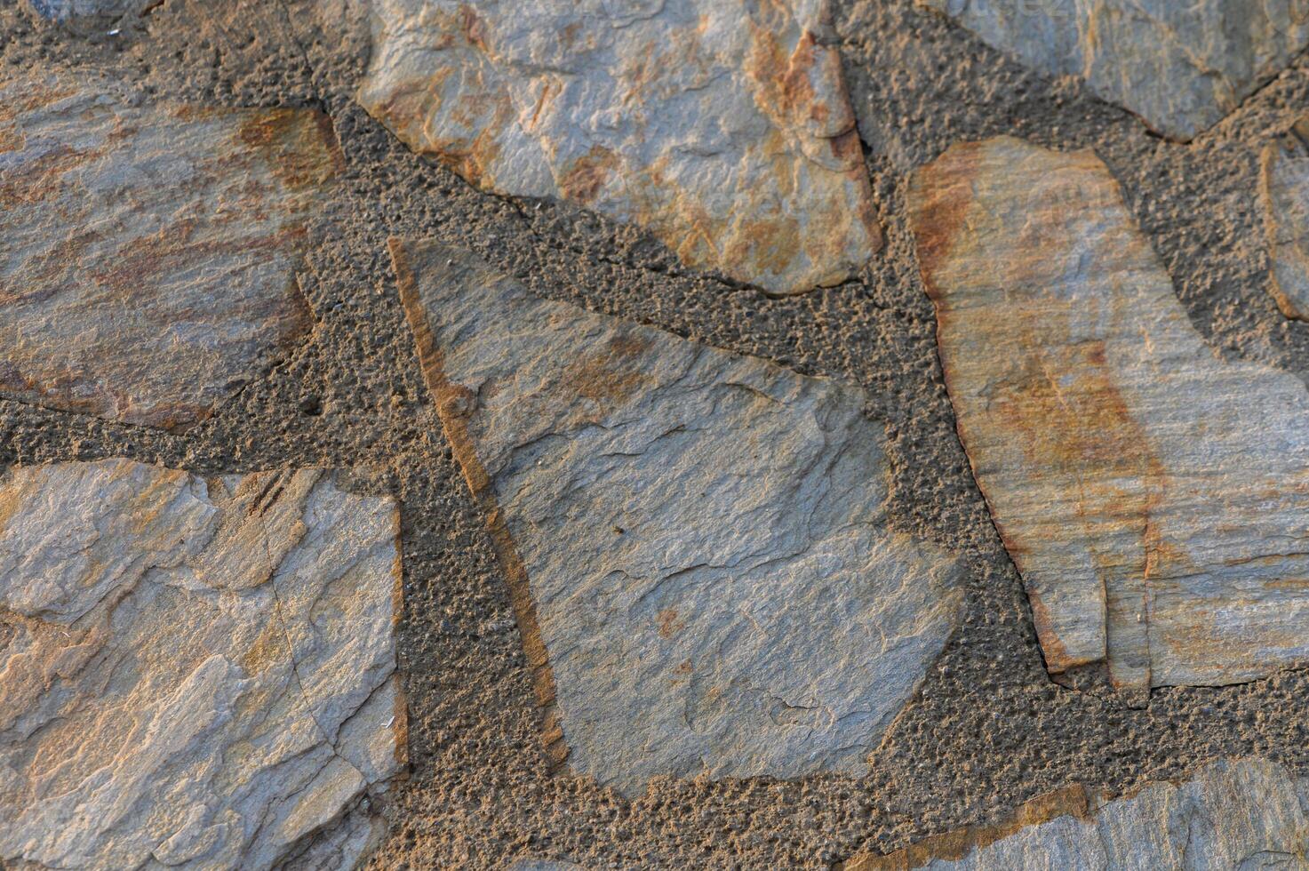 Intricate patterns of natural stone showcasing earthy tones and textures in a rustic setting photo