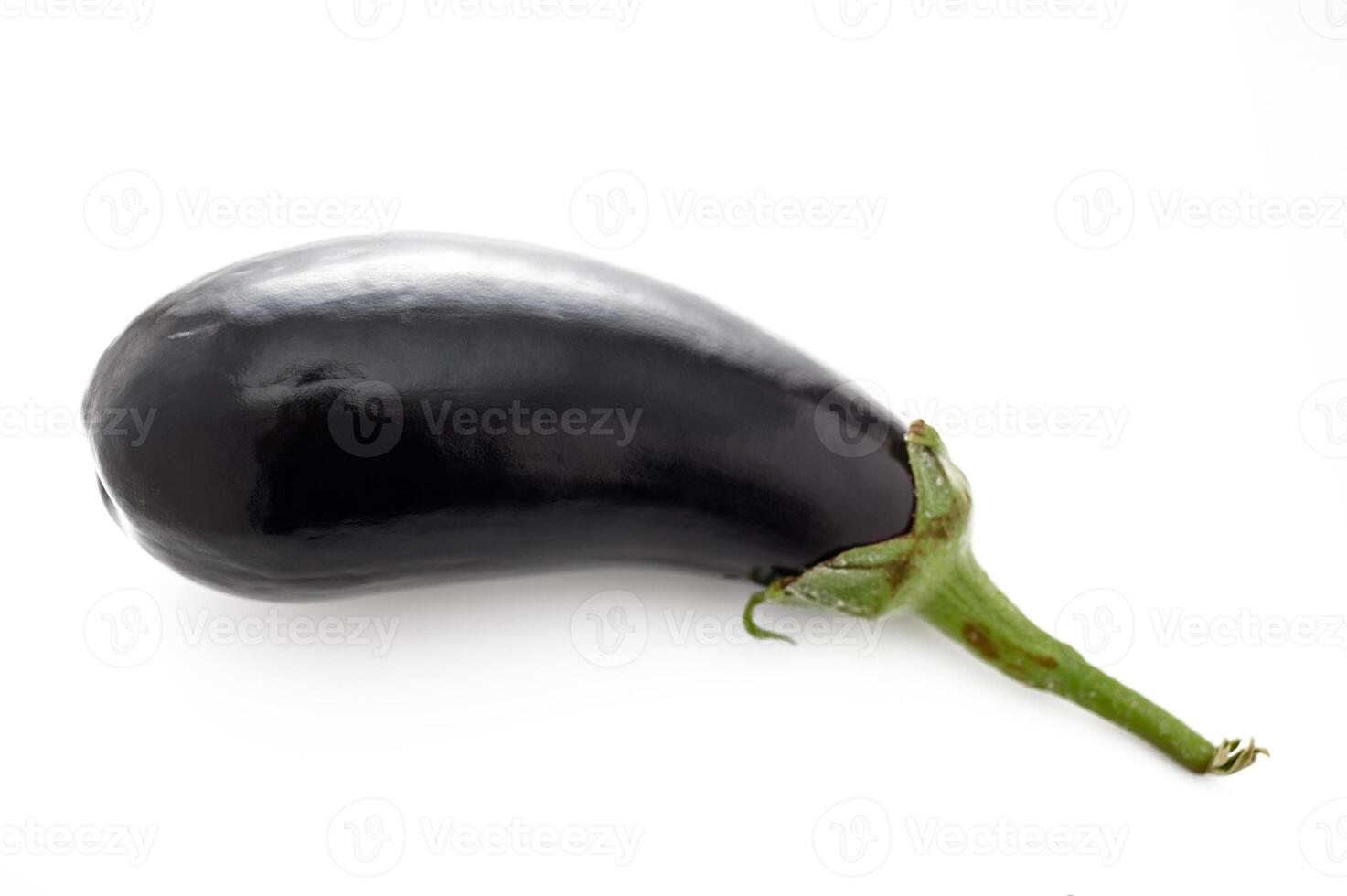 Fresh and glossy eggplant resting on a clean surface, ready for culinary adventures and delicious recipes photo