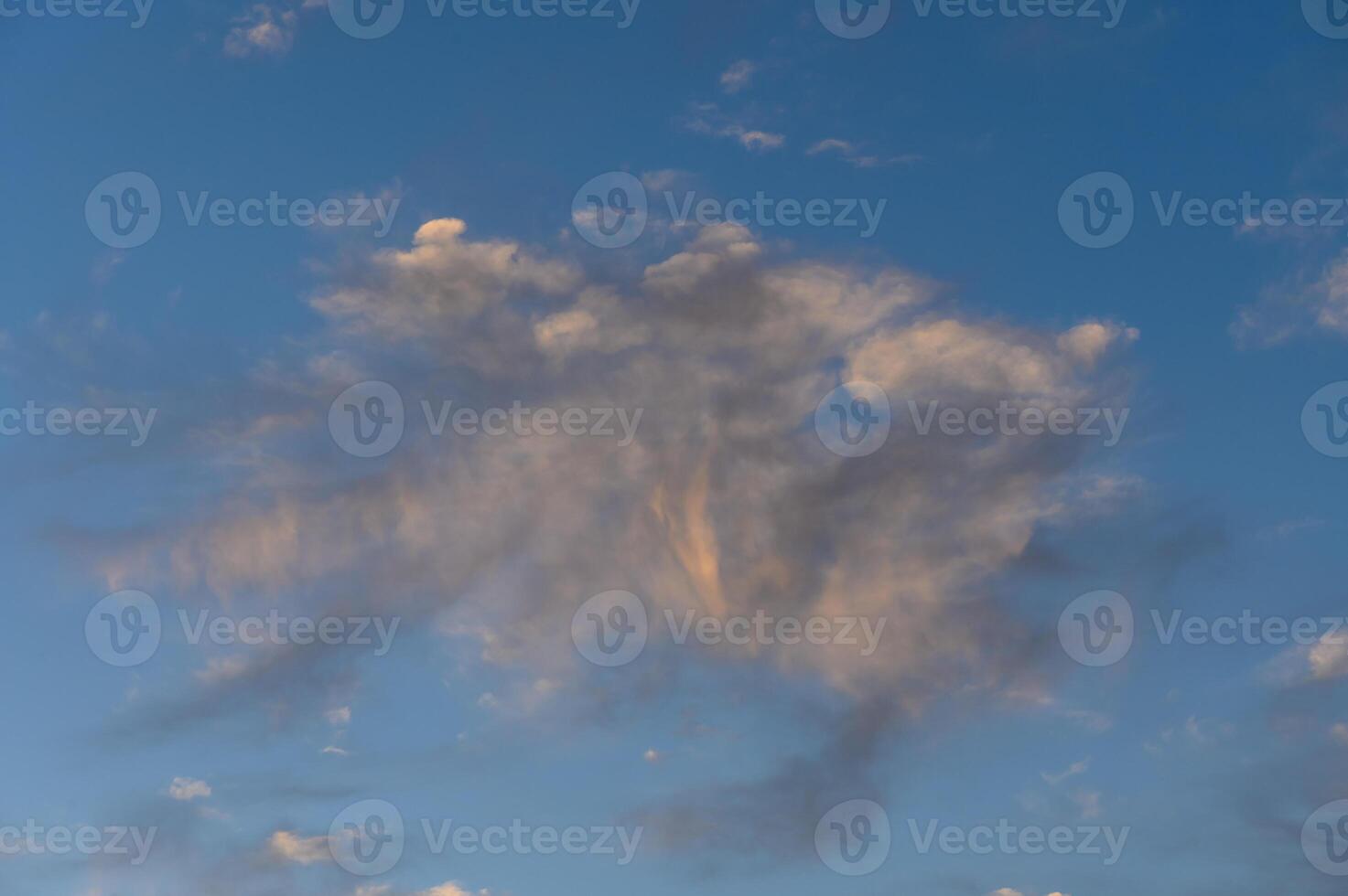 Whispers of clouds dance in the evening sky, showcasing nature's artistry at sunset photo