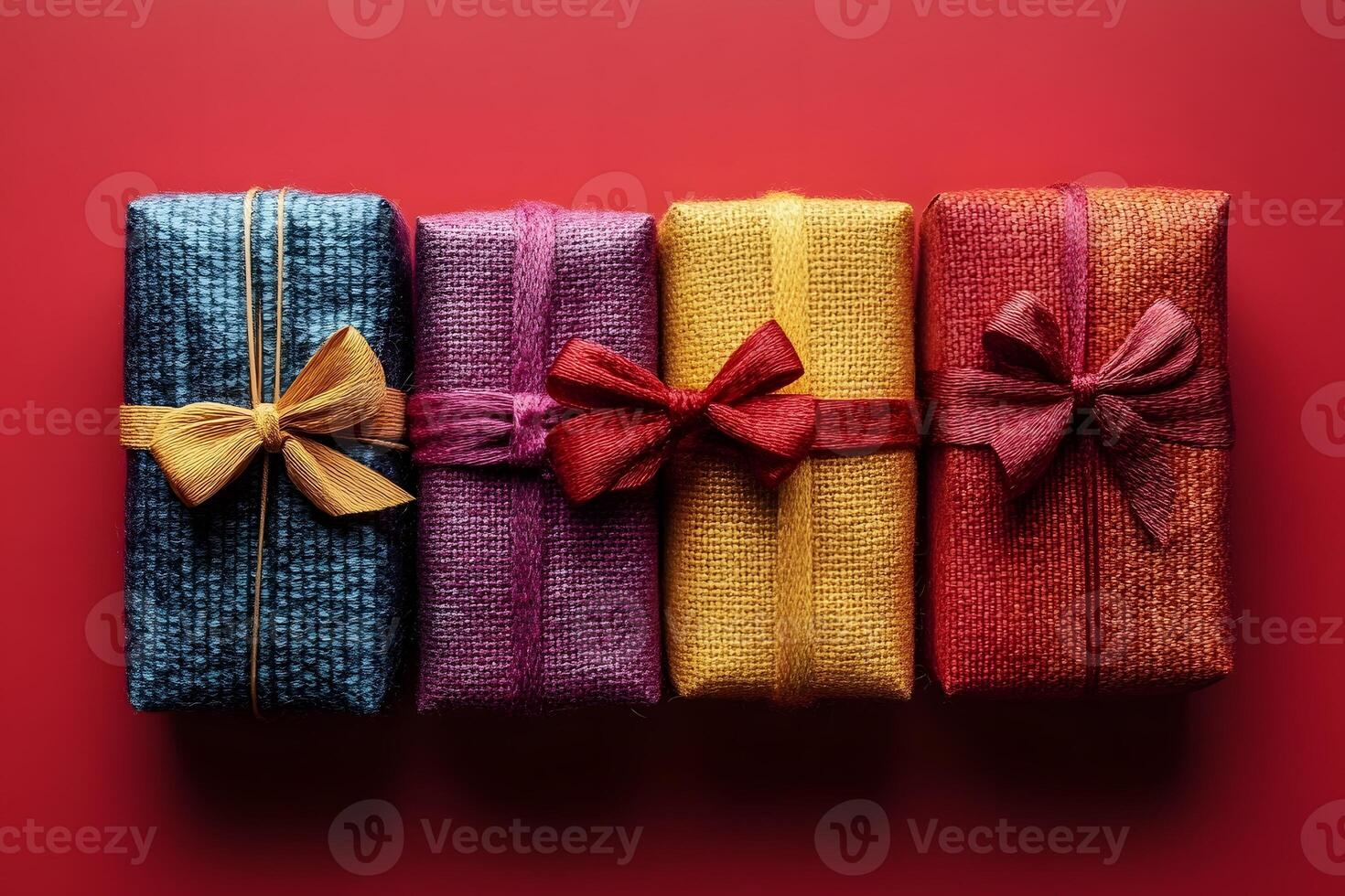 Colorful Gift Boxes Wrapped in Burlap with Bows on Red Background for Celebration and Decor photo