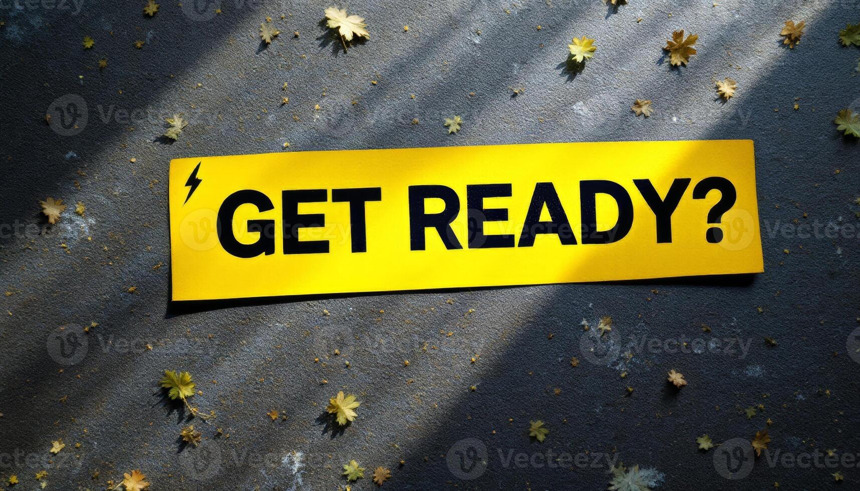A stark yellow banner demanding ,GET READY,, amidst fallen autumn leaves and stark shadows asks a silent question photo