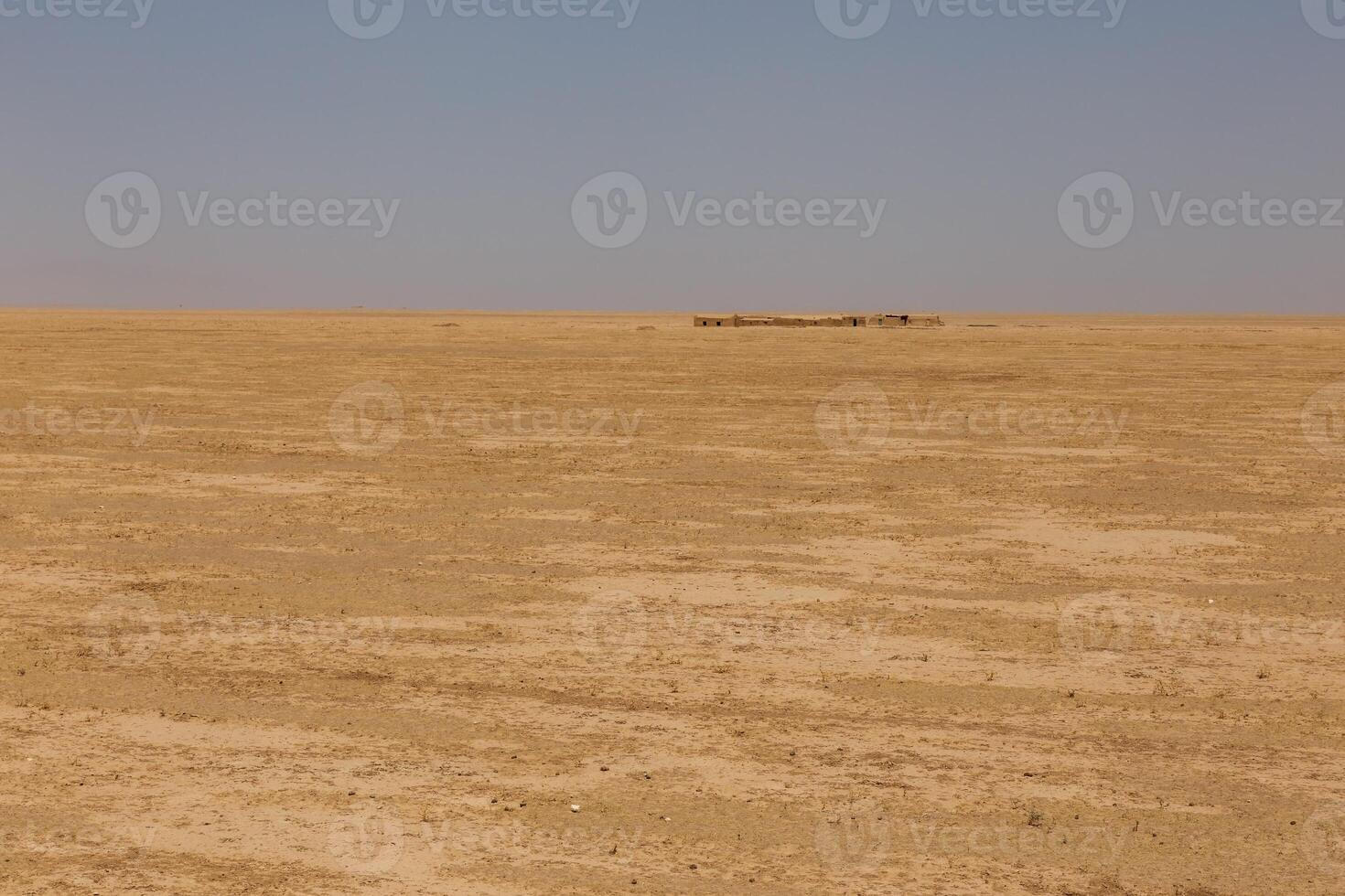 Expansive open landscape in Kunduz Province, Afghanistan during a clear day photo