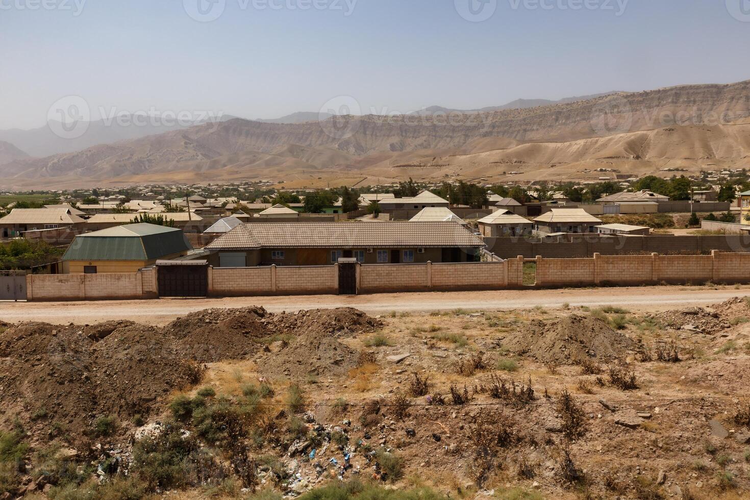 View of Obikiik village in Khuroson District, Khatlon Region, Tajikistan under clear skies photo