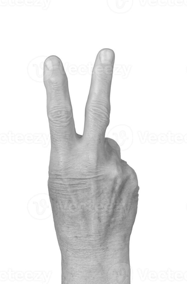 V sign hand gesture. Senior woman s wrinkled hand forming a V shape with two fingers raised, photo
