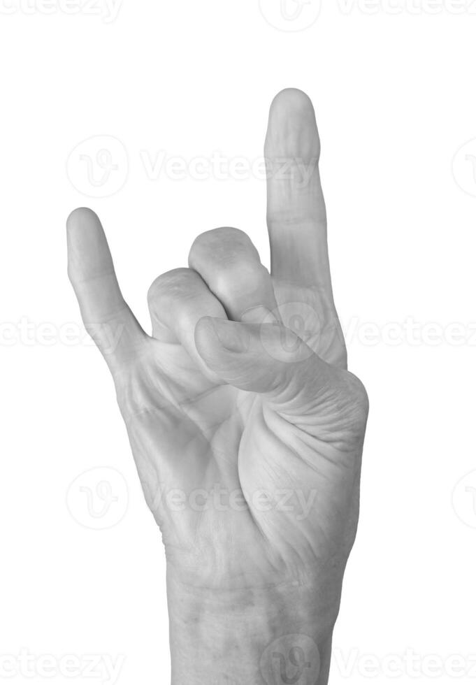 Rock hand sign. Senior woman s wrinkled hand showing the horns gesture, symbolizing rock and roll, photo