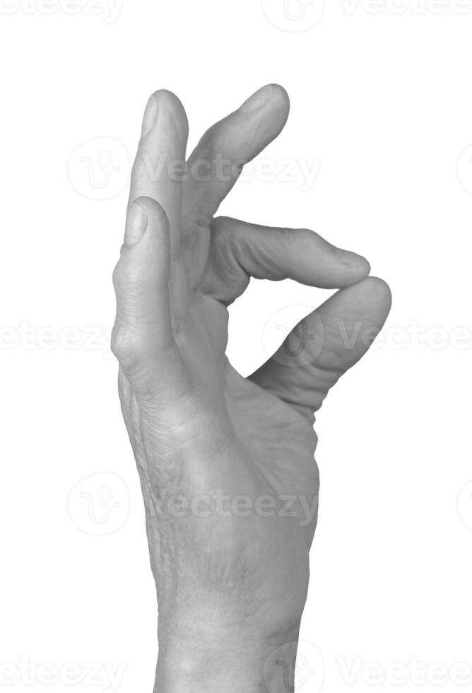 Pinch gesture. Senior woman s hand holding something small between thumb and forefinger, showing a photo