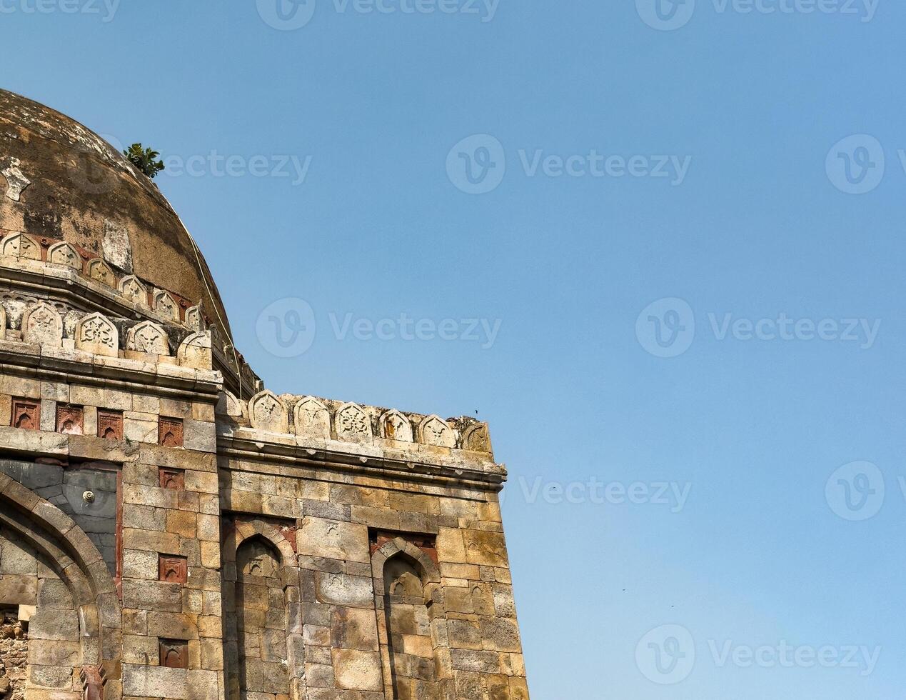 Ancient Indian building. Mughal stone architecture with decorative carvings, old dome. Historical photo