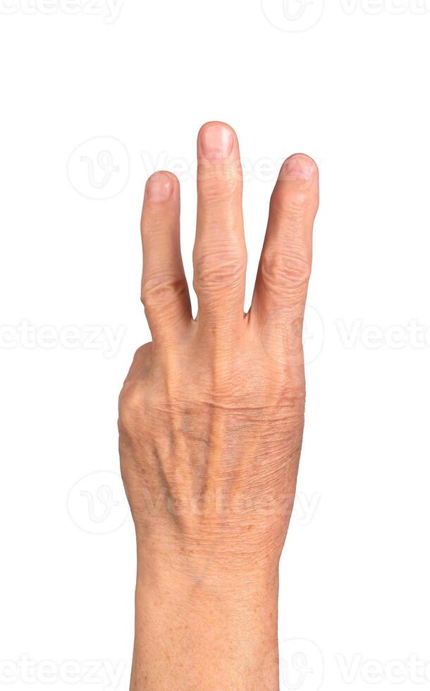 Three finger gesture. Senior Caucasian woman s wrinkled hand with three fingers raised, symbolizing photo