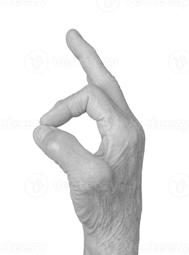 OK hand gesture. Senior woman s wrinkled hand forming a circle with thumb and forefinger, photo