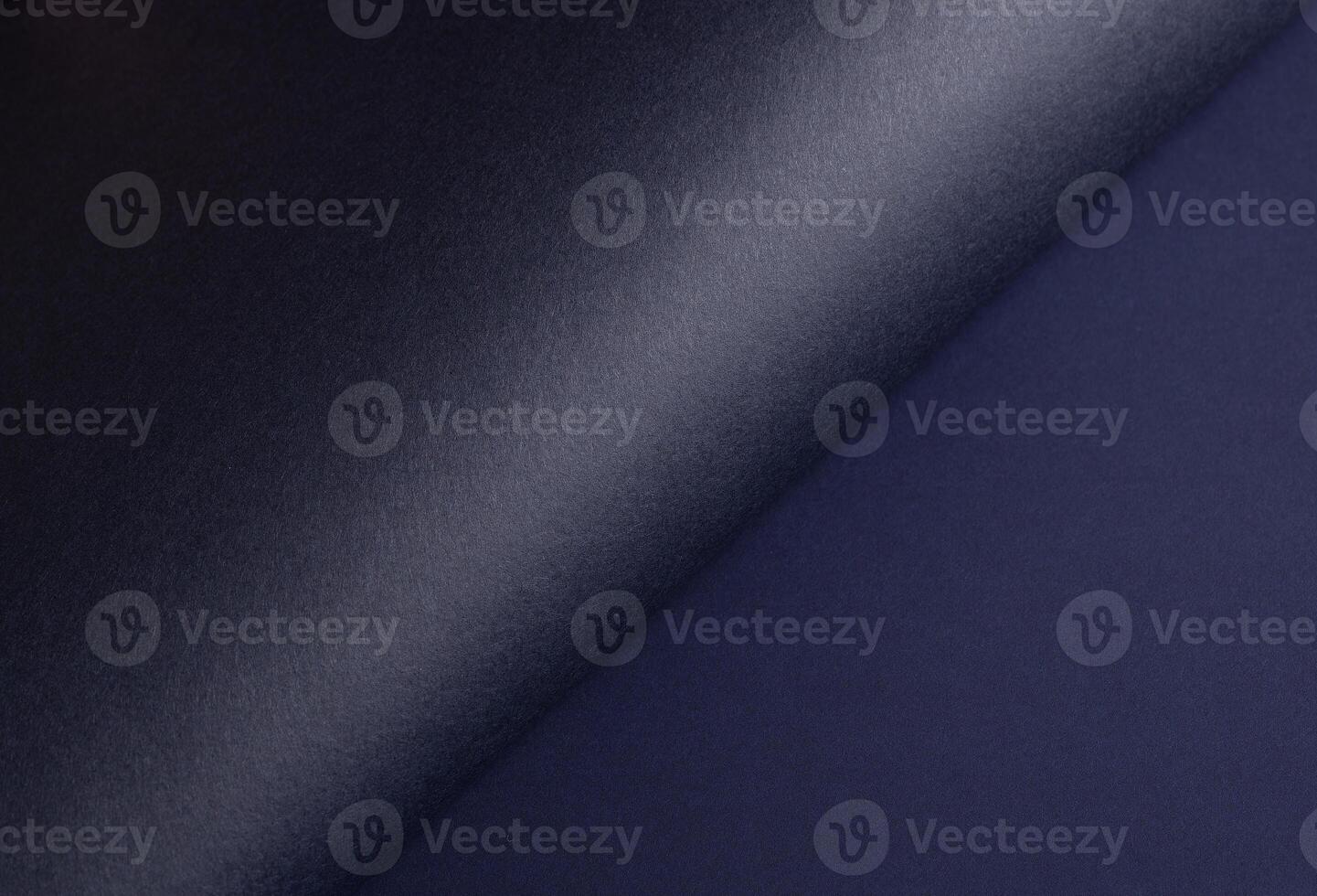 Midnight blue paper background with a gradient, curved matte surface, and subtle grainy texture. photo