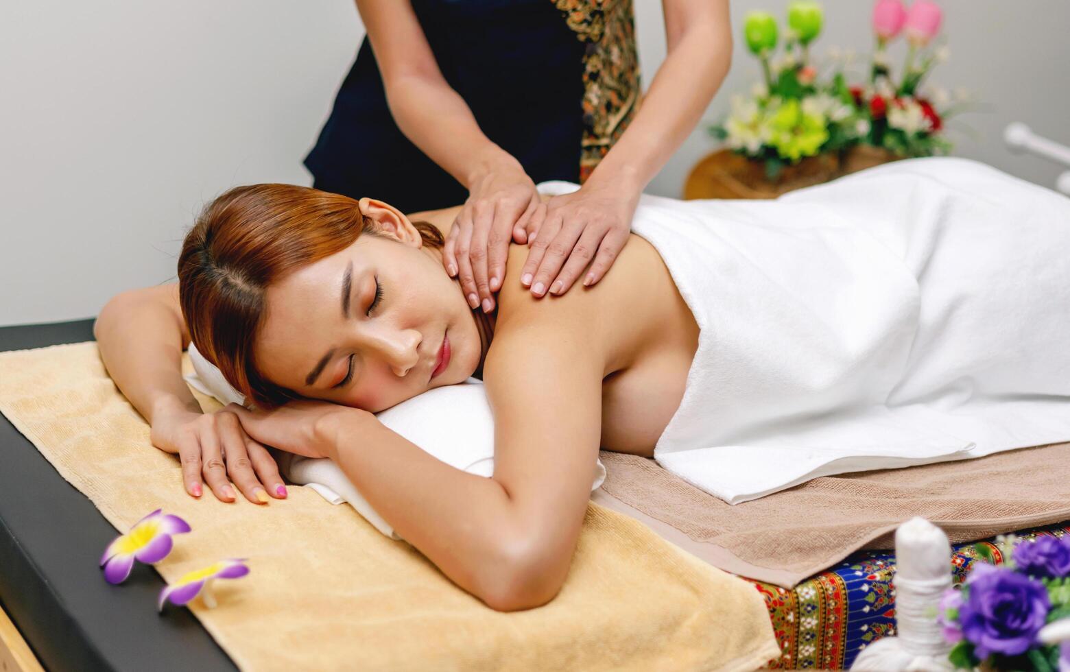 woman is getting a massage on a massage table photo