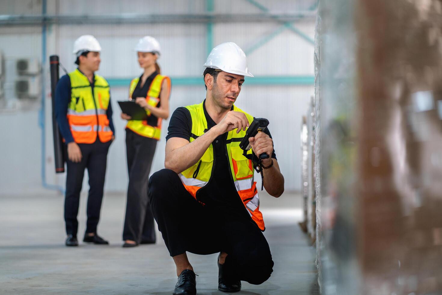man in a yellow vest is checking a barcode with a scanner photo
