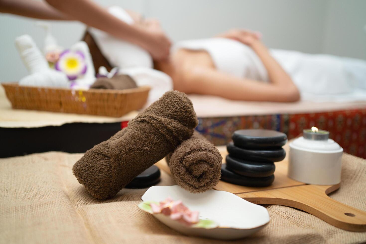 woman is getting a facial treatment with a basket of towels photo