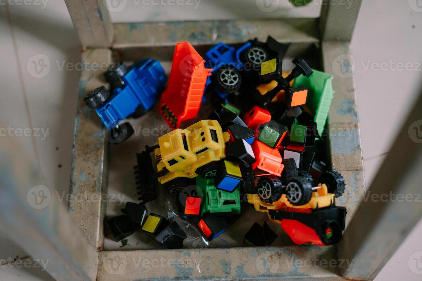 Pile of colorful toy trucks and blocks in a metal container, perfect for playtime so nice photo